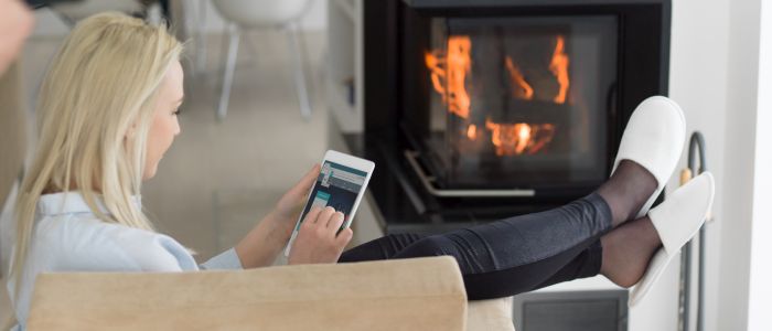 femme se réchauffant devant un poêle