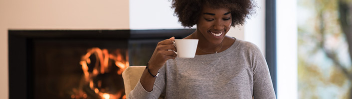 femme se relaxant dans son fauteuil avec une tasse