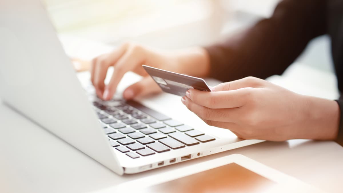 personne avec carte payant en ligne sur son ordinateur